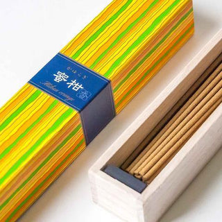 Striped incense box with open lid revealing brown incense sticks inside