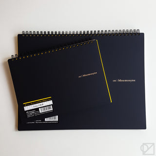 Grid spiral notebook, black back cover with gold graphics and gold rings