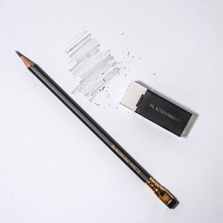 Blackwing eraser holder next to yellow pencil, white eraser block