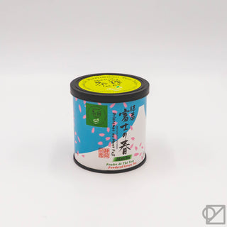Ceremonial grade matcha tin on plain background, black lid and colorful label