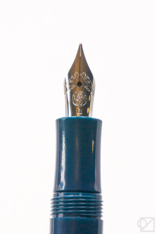 Gold fountain pen nib with Kaweco logo on teal barrel