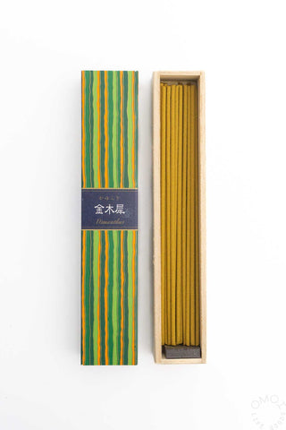 Striped incense box with bundle of yellow-brown incense sticks