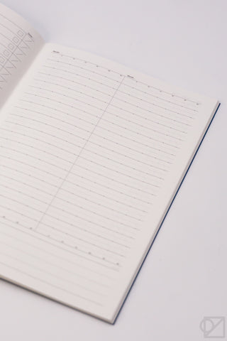 A5 spreadsheet notebook page with grid lines and a blue spine edge.