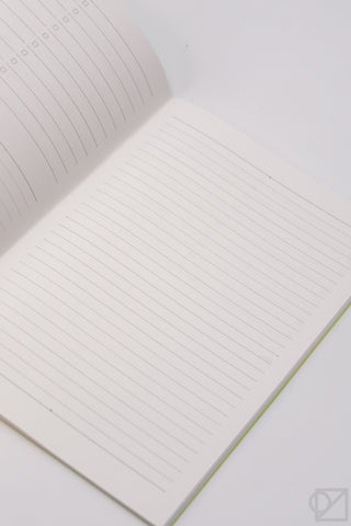 A5 spreadsheet notebook open flat with blank lined grid pages and a light green spine