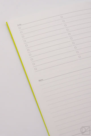 A5 spreadsheet notebook with white pages and yellow binding, featuring checklist-style rows