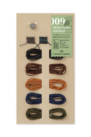Brown notebook repair kit with multiple color cords and small metal tool pieces