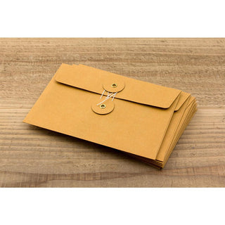 Stack of orange kraft envelopes with flap and two metal eyelet closures