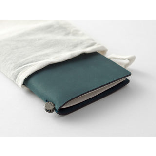 Blue leather passport notebook cover wrapped with white cloth and secured button