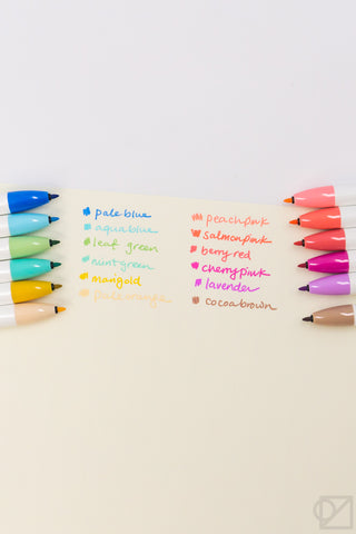 Pastel color names beside retractable marker pens in 12-light shades