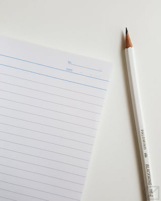 Lined notebook page with blue date line and pencil beside it