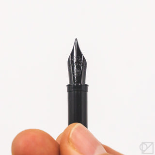 Kaweco black steel fountain pen nib marked 060, held in hand close-up