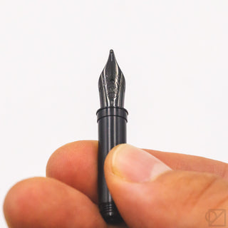 Kaweco black steel nib 060, close-up held by fingers showing engraving