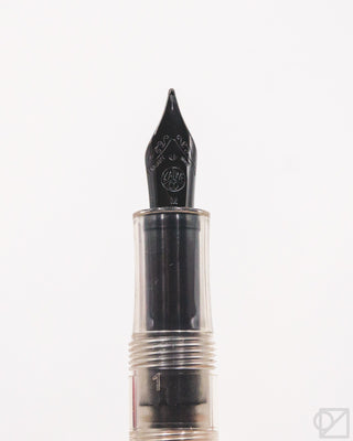 Black crystal fountain pen nib and feed, medium nib tip close-up.