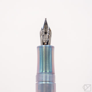 Fountain pen nib and iridescent pearl barrel in close-up view