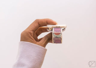 Hand holding KOKUYO Karu-Cut clip with patterned washi tape