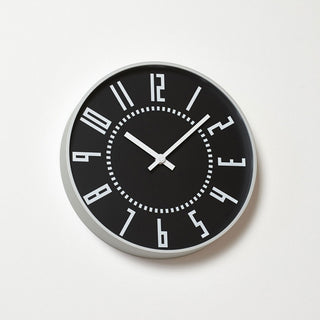 Black round wall clock with silver bezel, dotted minute track, white hour markers