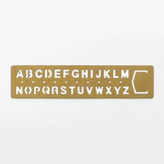Brass alphabet template bookmark featuring engraved letter cutouts A–Z