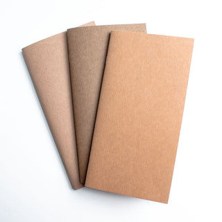 Set of blank notebooks with brown kraft covers, stacked side by side