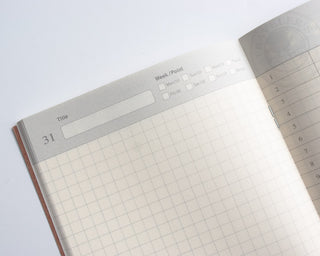 Traveler's notebook page close-up with grid and checklist header