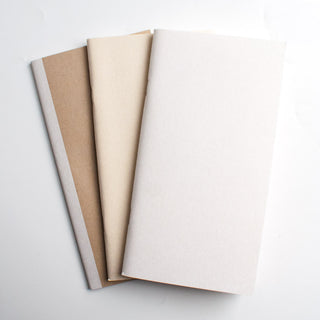 Sketch paper sheets in tan and cream, neatly stacked