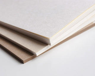 Kraft paper notebook with layered page edges and slightly open cover