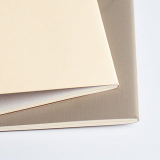 Close-up of beige planner page stack and stitched edge binding