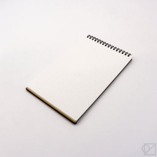 A5 spiral memo notebook with white grid pages and black metal spiral binding
