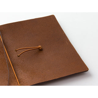 Camel brown leather notebook cover with cord lacing tied in place