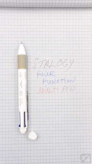 White 4Functions pen on grid paper with handwritten notes beside it