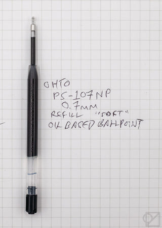 Black 0.7mm pen refill cartridge on grid paper with handwritten notes