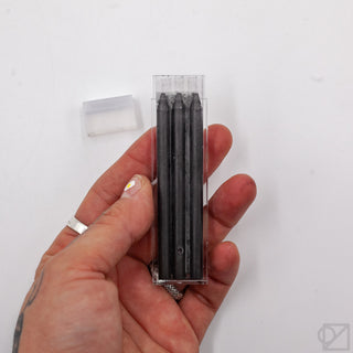 Kaweco 5B 5.6mm lead refills in clear case, black leads held in hand