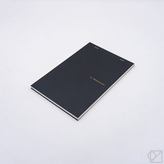 Black grid notepad with gold logo on cover and white inner page border