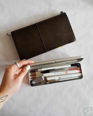 Dark brown pen case with hinged lid, open organizer with pens