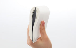 A5 notebook held open, showing white cover and narrow black page edge