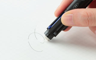 Close-up of black 4Functions pen tip with blue accent