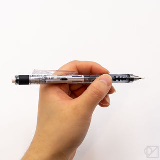Blue and black mechanical pencil held in hand, showing retractable lead tip