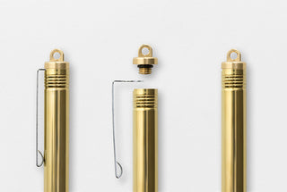 Brass ballpoint pen in closed position with metal clip and loop holder