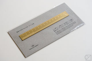 Brass metric ruler in box packaging with gold ruler and printed label