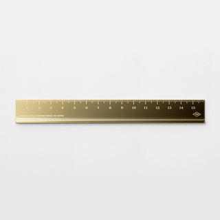Brass metric ruler laid flat with engraved centimeter and millimeter markings