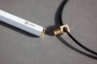 Two portable ballpoint pens with gold tips: light gray and dark barrels