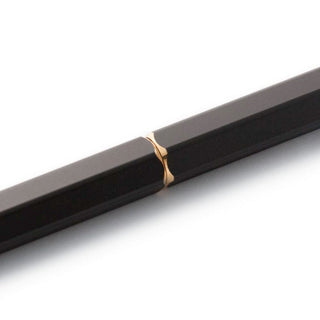 Black ballpoint pen barrel with a gold ring detail near the tip