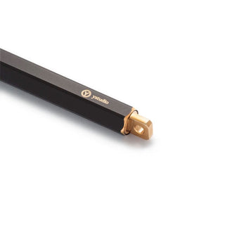Black portable ballpoint pen with gold clip and cap tip